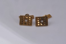 Gold pair of cufflinks